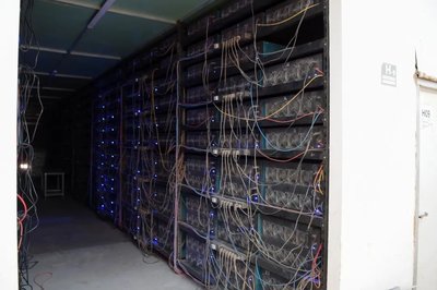 A Bitcoin mining farm showcasing rows of mining machines working simultaneously