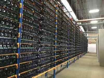 Aerial view of a modern mining farm with rows of cooling fans