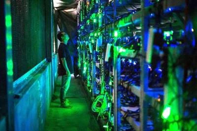 An image showcasing a large-scale mining farm with rows of mining rigs, emphasizing the scale and energy demands of such operations.
